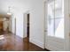 Spacious hallway with hardwood floors, white walls, and an entrance to an office area at 3364 Knollwood Nw Dr, Atlanta, GA 30305