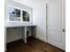 Home office features hardwood floors, white desk and trim, and window at 3364 Knollwood Nw Dr, Atlanta, GA 30305