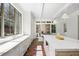 Bright, open kitchen boasts marble countertops, white cabinetry, and stainless steel sink at 3364 Knollwood Nw Dr, Atlanta, GA 30305