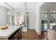 Gourmet kitchen with a large island, counter seating, and doors leading to an outdoor living space at 3364 Knollwood Nw Dr, Atlanta, GA 30305