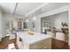 Bright, open kitchen boasts marble countertops, white cabinetry, and access to outdoor dining at 3364 Knollwood Nw Dr, Atlanta, GA 30305