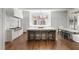 Open kitchen with stainless steel appliances, an oversized center island with seating, and ample natural light at 3364 Knollwood Nw Dr, Atlanta, GA 30305