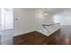Open-concept living space with hardwood floors, white walls, and a decorative chandelier at 3364 Knollwood Nw Dr, Atlanta, GA 30305
