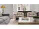 Elegant living room featuring a modern sofa, stylish chairs, and a clear view to the breakfast nook at 3364 Knollwood Nw Dr, Atlanta, GA 30305