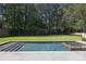 Beautiful backyard pool featuring a built-in spa, patio and lush green landscaping at 3364 Knollwood Nw Dr, Atlanta, GA 30305
