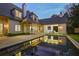 An expansive pool reflects the home's architecture, enhanced by an inviting patio and an open-air seating area at 3364 Knollwood Nw Dr, Atlanta, GA 30305