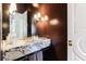 Chic powder room featuring marble countertop, unique lighting fixtures, and stylish accents, creating a luxurious feel at 3364 Knollwood Nw Dr, Atlanta, GA 30305
