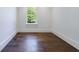 Unfurnished room with hardwood floors and natural light from windows at 3364 Knollwood Nw Dr, Atlanta, GA 30305