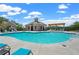 Community pool with clear blue water and sun loungers offers a relaxing atmosphere for residents on a sunny day at 655 Summit Hill Way, Cumming, GA 30040