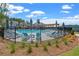 A community pool area with lounge chairs, umbrellas, and clubhouse with mountain views against a bright blue sky at 655 Summit Hill Way, Cumming, GA 30040