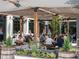 Outdoor seating area at Market Street Bar, featuring string lights and patrons enjoying a meal at 655 Summit Hill Way, Cumming, GA 30040