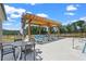 The community pool boasts a wooden pergola with lounge seating and side tables perfect for summer relaxation at 655 Summit Hill Way, Cumming, GA 30040