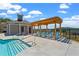 An inviting community pool features a pergola with lounge chairs and stairs leading into the refreshing water at 655 Summit Hill Way, Cumming, GA 30040
