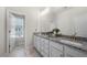 Bright bathroom featuring granite countertops, double sinks, and tiled floors at 82 Rising Fawn Ln, Marietta, GA 30060