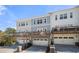 Multi-level townhome exterior with garage and balcony overlooking lush landscaping and blue sky at 82 Rising Fawn Ln, Marietta, GA 30060