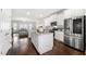 Open kitchen featuring white cabinets, stainless steel appliances, island, and hardwood floors at 82 Rising Fawn Ln, Marietta, GA 30060