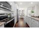 Bright kitchen featuring stainless steel appliances, granite countertops, and a view into the dining area at 82 Rising Fawn Ln, Marietta, GA 30060