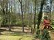 Backyard features a wood fence surrounding a playset, perfect for outdoor activities at 1603 Pinder Point Dr, Lawrenceville, GA 30043