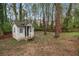 Backyard featuring a playhouse and mature trees at 1603 Pinder Point Dr, Lawrenceville, GA 30043