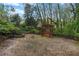 Backyard with a stone-lined pond and a relaxing swing under a pergola at 1603 Pinder Point Dr, Lawrenceville, GA 30043