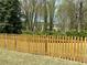 Backyard featuring a manicured lawn and a classic wooden picket fence at 1603 Pinder Point Dr, Lawrenceville, GA 30043