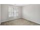 Bedroom with neutral carpet, white trim, and plantation shutters at 1603 Pinder Point Dr, Lawrenceville, GA 30043