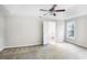 Spacious bedroom with neutral carpeting, tray ceilings, and access to ensuite bathroom at 1603 Pinder Point Dr, Lawrenceville, GA 30043