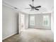 Large carpeted bedroom featuring tray ceiling, fan and natural light at 1603 Pinder Point Dr, Lawrenceville, GA 30043