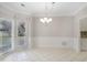 Bright dining area featuring tile flooring, wainscoting, and large windows at 1603 Pinder Point Dr, Lawrenceville, GA 30043