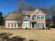 Charming two-story brick home with green shutters and a well-manicured front yard at 1603 Pinder Point Dr, Lawrenceville, GA 30043
