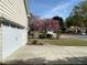 Home exterior featuring mature trees, lovely landscaping and an attached two-car garage at 1603 Pinder Point Dr, Lawrenceville, GA 30043