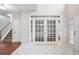 Grand foyer with tile flooring, double doors to office and staircase at 1603 Pinder Point Dr, Lawrenceville, GA 30043