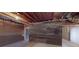 An unfinished basement area with exposed beams provides an opportunity for customization at 7492 Shadburn Ferry Rd, Cumming, GA 30041