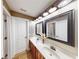 Bathroom featuring a double sink vanity with decorative mirrors and lighting at 7492 Shadburn Ferry Rd, Cumming, GA 30041