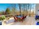 Spacious deck with wood flooring, outdoor dining set, and a wooded view at 7492 Shadburn Ferry Rd, Cumming, GA 30041