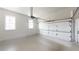 Spacious three-car garage with smooth concrete floor and two windows at 7492 Shadburn Ferry Rd, Cumming, GA 30041