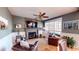 Comfortable living room featuring a stone fireplace and a ceiling fan at 7492 Shadburn Ferry Rd, Cumming, GA 30041