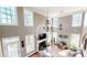Spacious living room featuring a fireplace, hardwood floors, and large windows for natural light at 7492 Shadburn Ferry Rd, Cumming, GA 30041