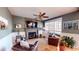 Cozy living room with a stone fireplace, comfortable seating, and a ceiling fan at 7492 Shadburn Ferry Rd, Cumming, GA 30041