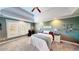 Comfortable main bedroom with tray ceilings, carpet, and ample natural light at 7492 Shadburn Ferry Rd, Cumming, GA 30041