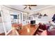 Well-lit home office with hardwood floors, a large desk, and French doors leading to the dining area at 7492 Shadburn Ferry Rd, Cumming, GA 30041