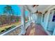 A charming porch with white railing offers a relaxing outdoor space overlooking the yard at 7492 Shadburn Ferry Rd, Cumming, GA 30041