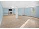 Finished basement with built-in shelves, a fireplace, and exterior access to the backyard at 1517 Cherry Hill Sw Rd, Conyers, GA 30094
