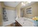 Bright bathroom featuring a shower-tub combo, large mirror, and vanity with floral decorations at 1517 Cherry Hill Sw Rd, Conyers, GA 30094
