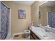 Full bathroom featuring a single sink vanity, a toilet, and a shower with a decorative curtain at 1517 Cherry Hill Sw Rd, Conyers, GA 30094