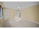 Comfortable bedroom featuring a ceiling fan and natural light, with access to an ensuite at 1517 Cherry Hill Sw Rd, Conyers, GA 30094