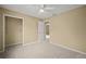 Inviting bedroom features neutral walls, a spacious closet, and a ceiling fan at 1517 Cherry Hill Sw Rd, Conyers, GA 30094