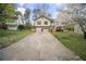 Split level home with neutral siding, attached two car garage, and long driveway at 1517 Cherry Hill Sw Rd, Conyers, GA 30094
