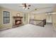 Living room with high ceilings, a stone fireplace, and carpet at 1517 Cherry Hill Sw Rd, Conyers, GA 30094