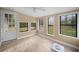 Bright sunroom with multiple windows and wood-look flooring, creating a relaxing space at 1517 Cherry Hill Sw Rd, Conyers, GA 30094